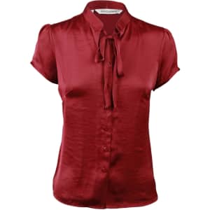 Red satin blouse with short sleeves and a tie neck detail, featuring a button-down front and a logo at the collar.