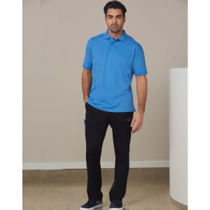 A model wearing a blue polo shirt and black cargo pants, standing against a neutral backdrop.