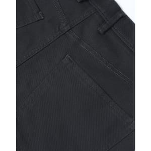 A close-up of dark grey flexi chino pants featuring detailed stitching and a back pocket design.