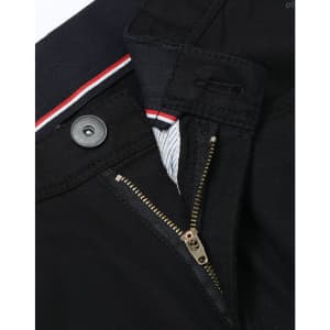 A close-up of black chino pants featuring a zip fly and button closure, with a striped waistband detail.