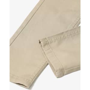 Flexi chino pants in a beige colour, featuring a tailored cut and visible stitching details. Includes a branding logo.