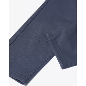 A close-up of navy blue flexi chino pants showing the stitching and hem details, including a logo.