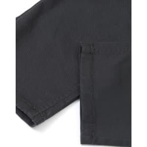 A close-up of black flexi chino pants showcasing the fabric texture and stitching details.