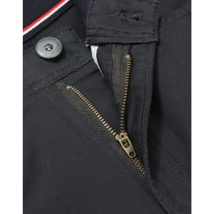 A close-up of a zipper and button detail on black chino pants, featuring sturdy fabric and an internal waistband design.