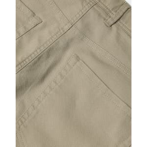 A close-up of khaki ladies' chino pants showcasing detailed stitching and pocket design. The pants have branding present.