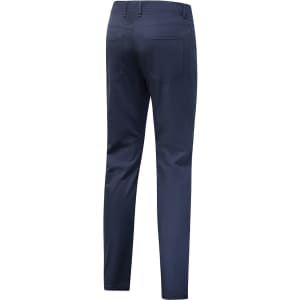 A pair of navy ladies' chino pants viewed from the back, featuring a slim fit and back pockets.
