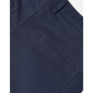 A close-up of navy flexi chino pants, highlighting the stitching and pocket details. The fabric appears sturdy and stylish.