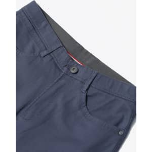 Navy flexi chino pants featuring a button closure, pockets, and a contrasting waistband. Includes branding.