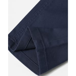 A close-up of folded navy blue chino pants featuring a smooth fabric texture and detailed stitching.