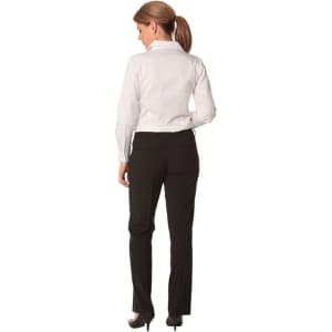A woman wearing black slim leg pants with a flexi waist, paired with a white shirt, seen from the back.