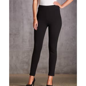 A pair of black treggings with a high waist and fitted design, accompanied by a model wearing black heels.