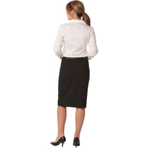 A women's black mid-length lined pencil skirt in wool stretch, worn with a white shirt and black heels.