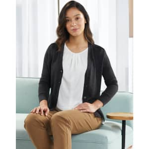 A dark grey, women's 100% merino wool long sleeve cardigan with buttons, worn over a white blouse.