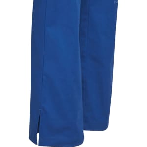 A pair of blue solid colour scrub pants with side slits at the hem, featuring a brand logo.