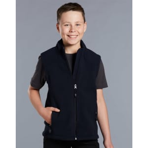 A boy wearing a navy blue fleece vest with a zip and side pockets, smiling against a grey background.
