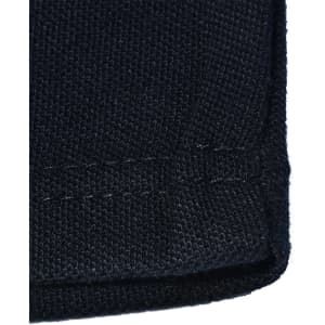 A close-up of a dark navy knit fabric with a hemmed edge, showcasing the texture and stitching details.