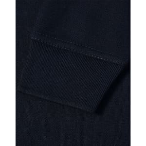 A close-up view of the cuff of a navy blue polo shirt featuring a ribbed design and a logo.