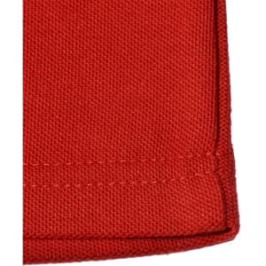 A close-up of a red poly/cotton pique knit fabric, showcasing the texture and stitching of a long sleeve polo shirt.