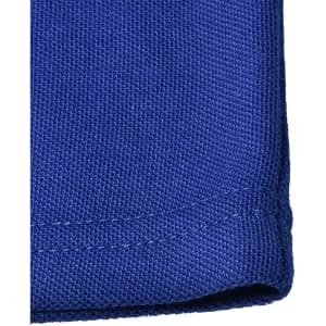 A close-up of a blue poly/cotton pique knit fabric with a neatly finished edge, featuring a logo.