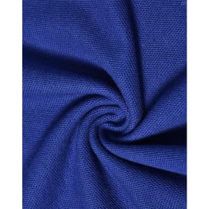 A close-up of textured blue fabric, showcasing the knit pattern of a poly/cotton pique material.