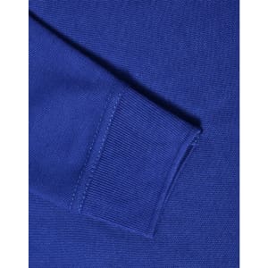 A close-up of a blue long sleeve polo shirt, showcasing the knit texture and ribbed cuff detail.