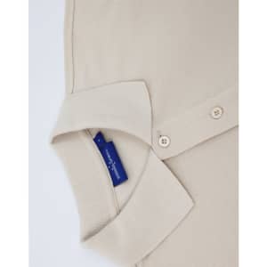A beige short-sleeve polo shirt with a collar and buttons, featuring a brand logo tag.
