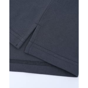 A close-up of a dark grey cotton/poly pique polo shirt, featuring seams and a small side split.