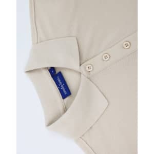 A beige ladies' classic cotton/poly pique short sleeve polo with a collar and buttons, featuring a branded label inside.