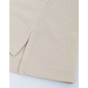 A close-up of a beige cotton/poly pique fabric, showcasing its texture and stitching details. It features a simple hemline.