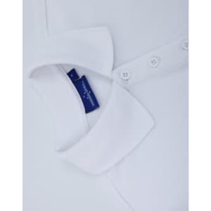 A white classic cotton/poly pique short sleeve polo shirt featuring a collar and buttons, with a tag visible.