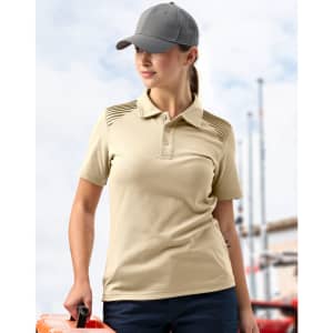 A model wears a beige polo shirt with textured detailing on the shoulders, paired with a grey cap.