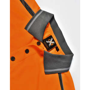 An orange polo shirt with grey accents and a logo at the collar, featuring buttons down the front.