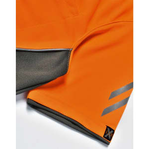 An orange polo shirt featuring grey accents and a logo on the hem.