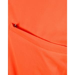 An orange polo shirt featuring a vented pocket, showcasing a breathable fabric texture.