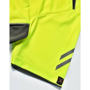 A close-up of a bright yellow polo shirt featuring grey accents and a logo on the hem.