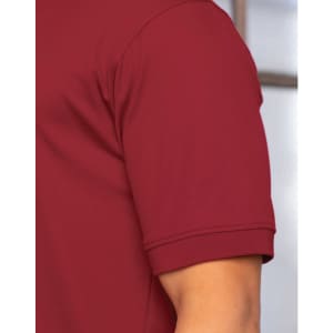A maroon polo shirt with a short sleeve and a logo on the chest. The fabric appears smooth and lightweight.