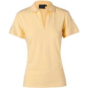 A light yellow women's polo shirt with a collar and short sleeves, featuring a brand logo.