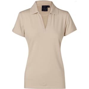 A beige ladies' polo shirt featuring a collar and a logo. Ideal for casual or sporty wear.