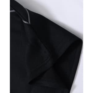 A close-up of a black polo shirt featuring short sleeves and a grey trim detail. The shirt has a logo.