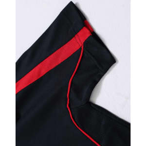 A black polo shirt with red and contrasting details, featuring a logo on the sleeve.