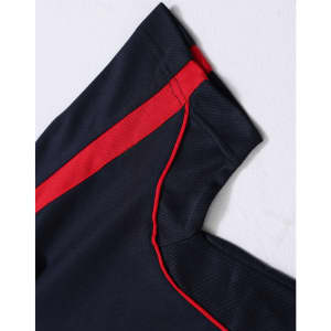 A navy polo shirt with red detailing along the seams and shoulders, featuring a branded logo.