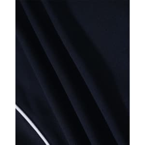 A close-up of a navy blue polo shirt fabric with a textured pattern and a white trim detail.
