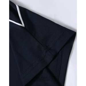 A close-up of a navy blue polo shirt featuring a white trim on the collar and sleeve.