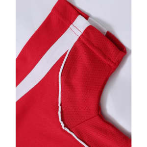 A red polo shirt featuring white accent details and a logo on the collar area.
