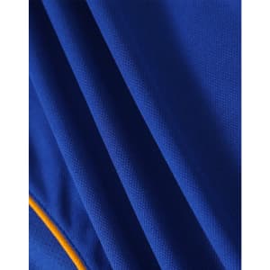 A close-up of a blue polo shirt with textured fabric and yellow accents, featuring a logo.