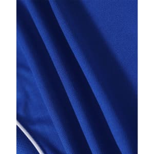 A close-up of a blue polo shirt made from textured fabric with contrasting stripes and a logo.