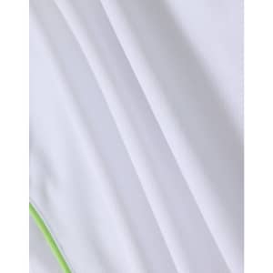 A close-up of a white polo shirt featuring a textured fabric and a green accent. The shirt has a logo.