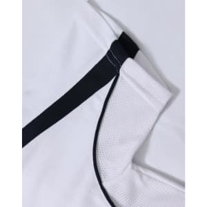 A white polo shirt with black trim and a textured fabric, featuring a logo.