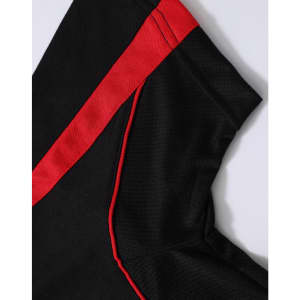 A close-up of a black polo shirt featuring red accents, highlighting the fabric texture and design details.