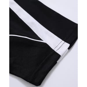 A close-up of a black polo shirt featuring white accents and a logo.
